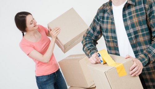 Experienced removals staff handling bulky furniture in a Hounslow property