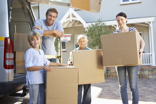 Furniture and boxes being transported by a local removal van