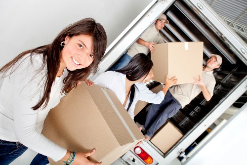 Careful loading of boxed household items for a move in Hounslow