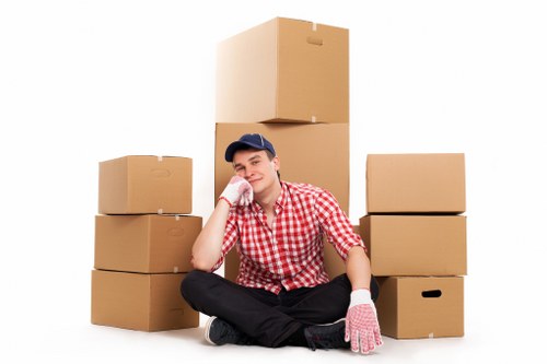 Movers handling furniture in a local Hounslow home